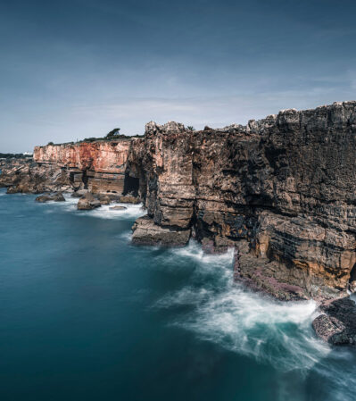 Boca do Inferno, part of Lisbon’s dramatic coast, is dominated by rugged cliffs and the misty-blue sea below. This image captures the raw beauty and power of nature, with a serene, yet dynamic interplay between the imposing rocks and the fluid motion of the ocean.